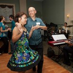 Man and woman smiling holding hand and dancing